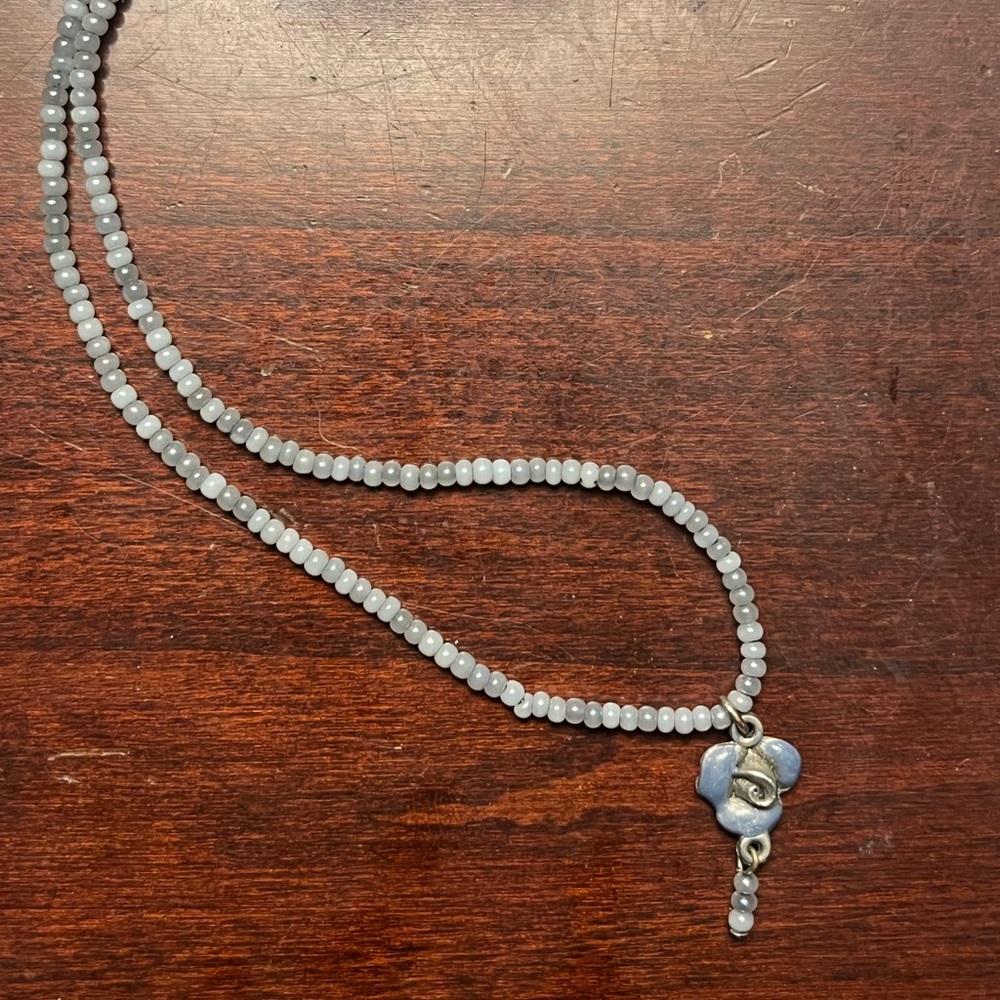 Blue beaded rose charm necklace.